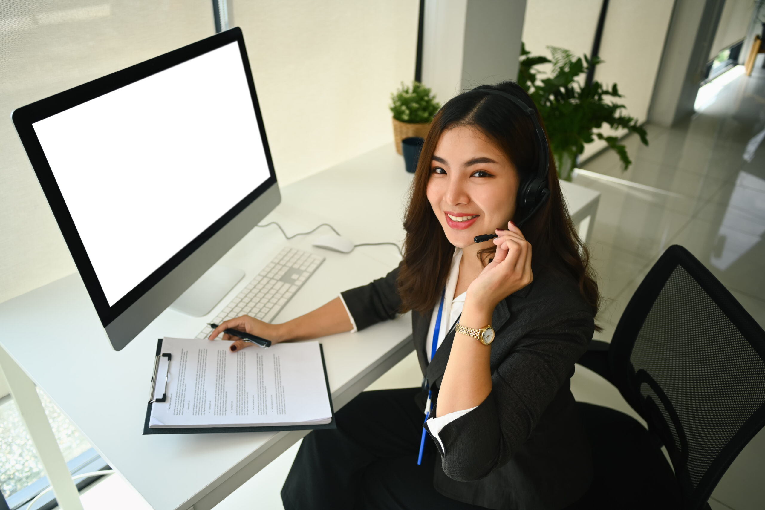Beautiful asian woman working at call center office to help people with telemarketing assistance.